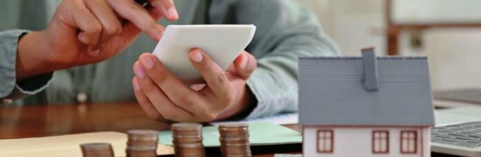 hand-is-using-calculator-to-calculate-the-home-exp-6bskcp8-scaled_695ad091e1fc4