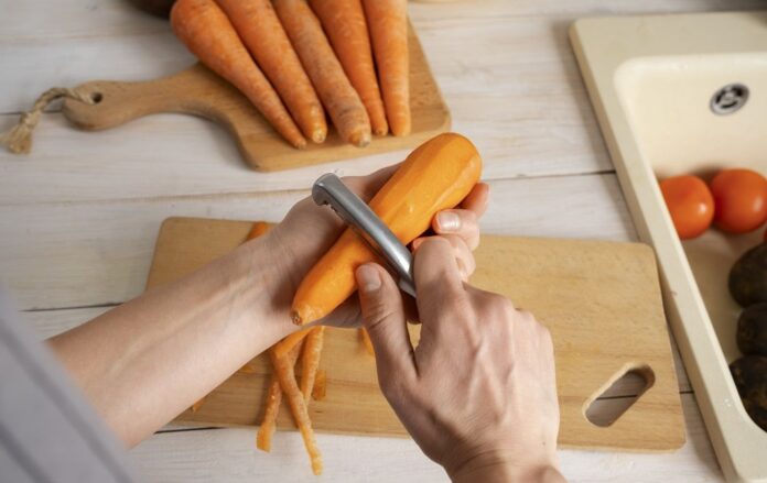 person_chopping_carrots_kitchen_64ad8493119cbc68572077a4cc436051_1300x820